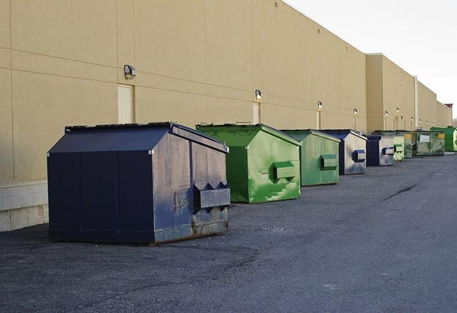 bright yellow construction dumpster full of discarded materials in Cabot